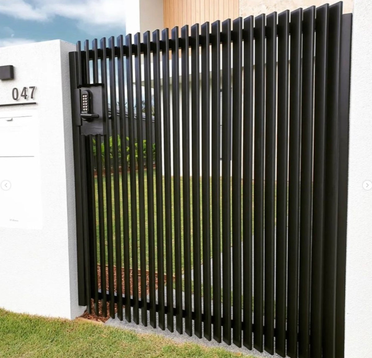 Black aluminum slat gate with square aluminum end caps fitted for a clean finish.