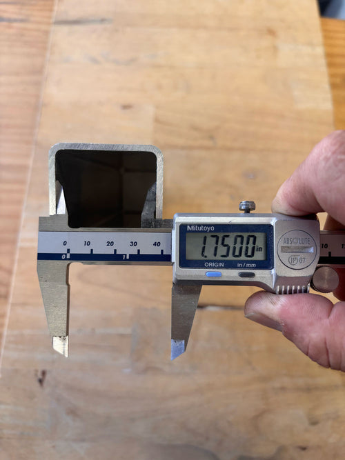 Digital caliper measuring internal width of aluminum tube