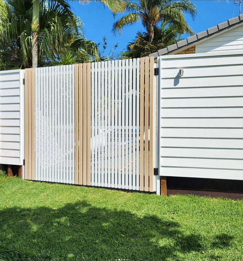 White and brown timber look aluminum fence with a house in the background