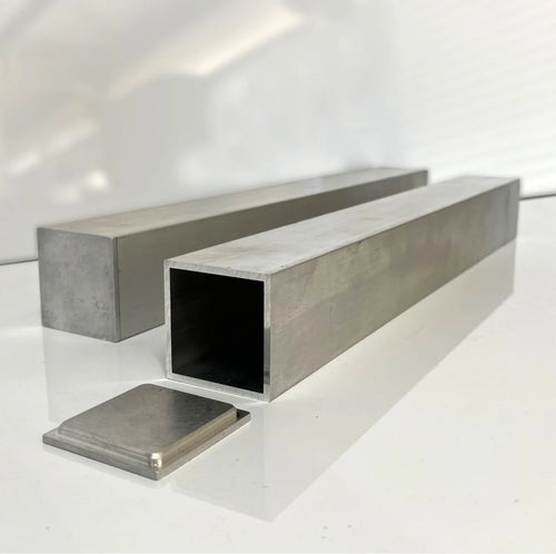 CNC machined aluminum end cap beside square aluminum tube sections