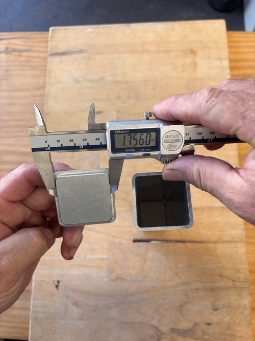 Digital caliper measuring internal fit of aluminum end cap to fit tube
