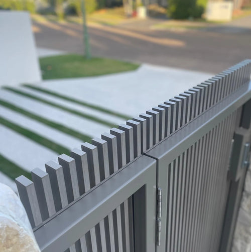 Grey aluminum fence with aluminum end caps secure on the ends