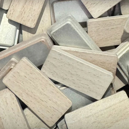 Stack of rectangular aluminum end caps painted with a neutral color palette