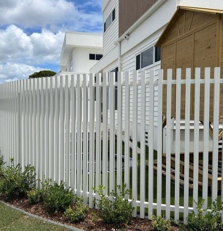 White vertical aluminum battens with interference-fit aluminum end caps installed on a modern balcony balustrade.