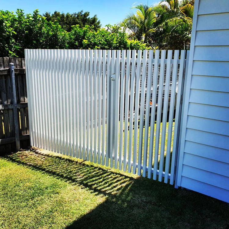 Aluminum batten fence with posts and rails finished using interference-fit aluminum end caps.