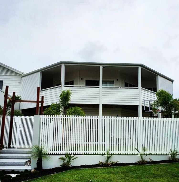 White aluminum front fence and balcony balustrade finished with square aluminum end caps.