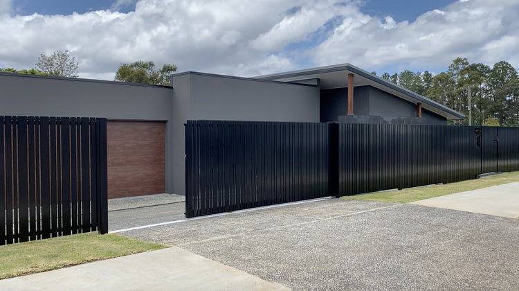 Aluminum sliding gate with vertical battens finished using aluminum end caps.
